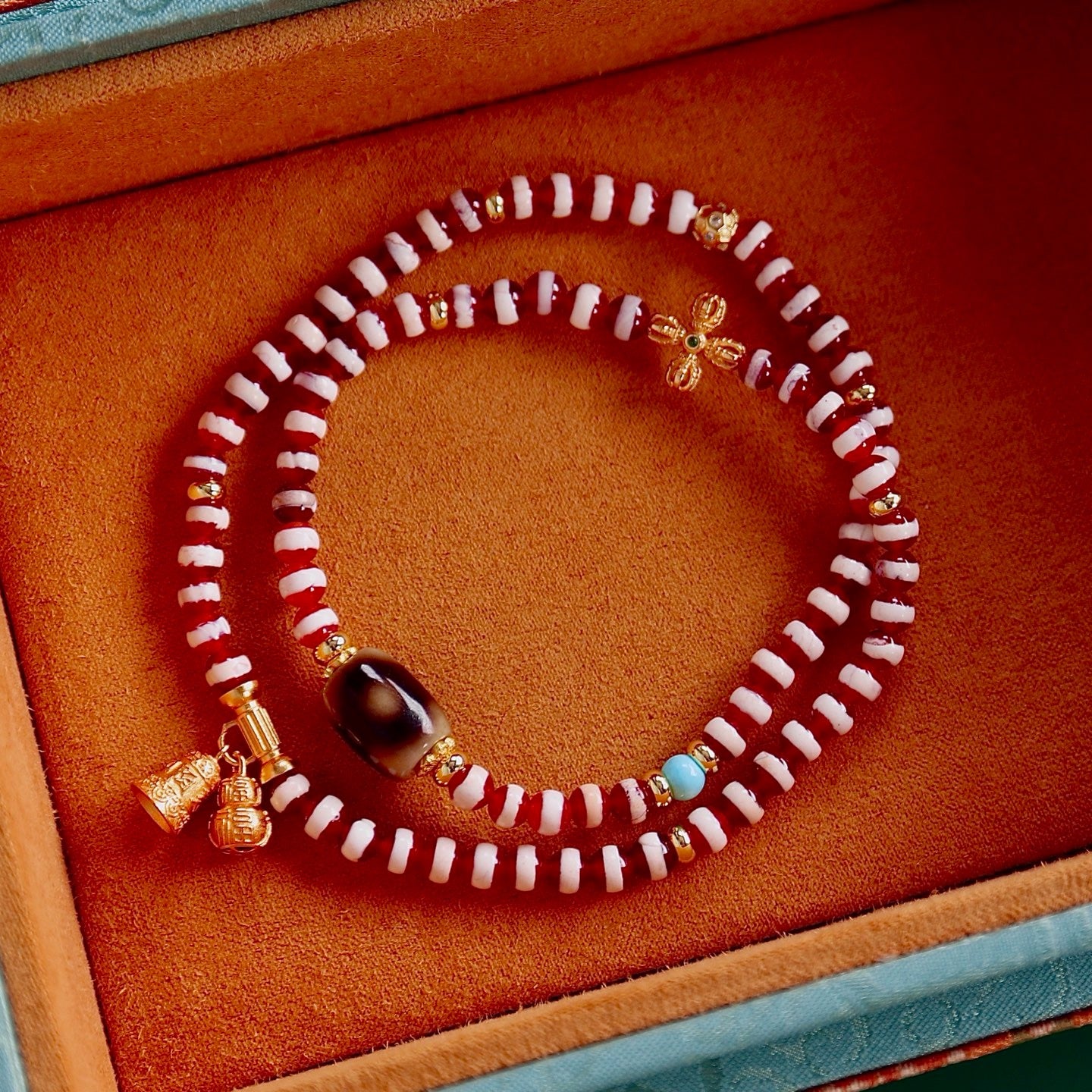 A bracelet made of natural red- meat medicine buddha dzi beads